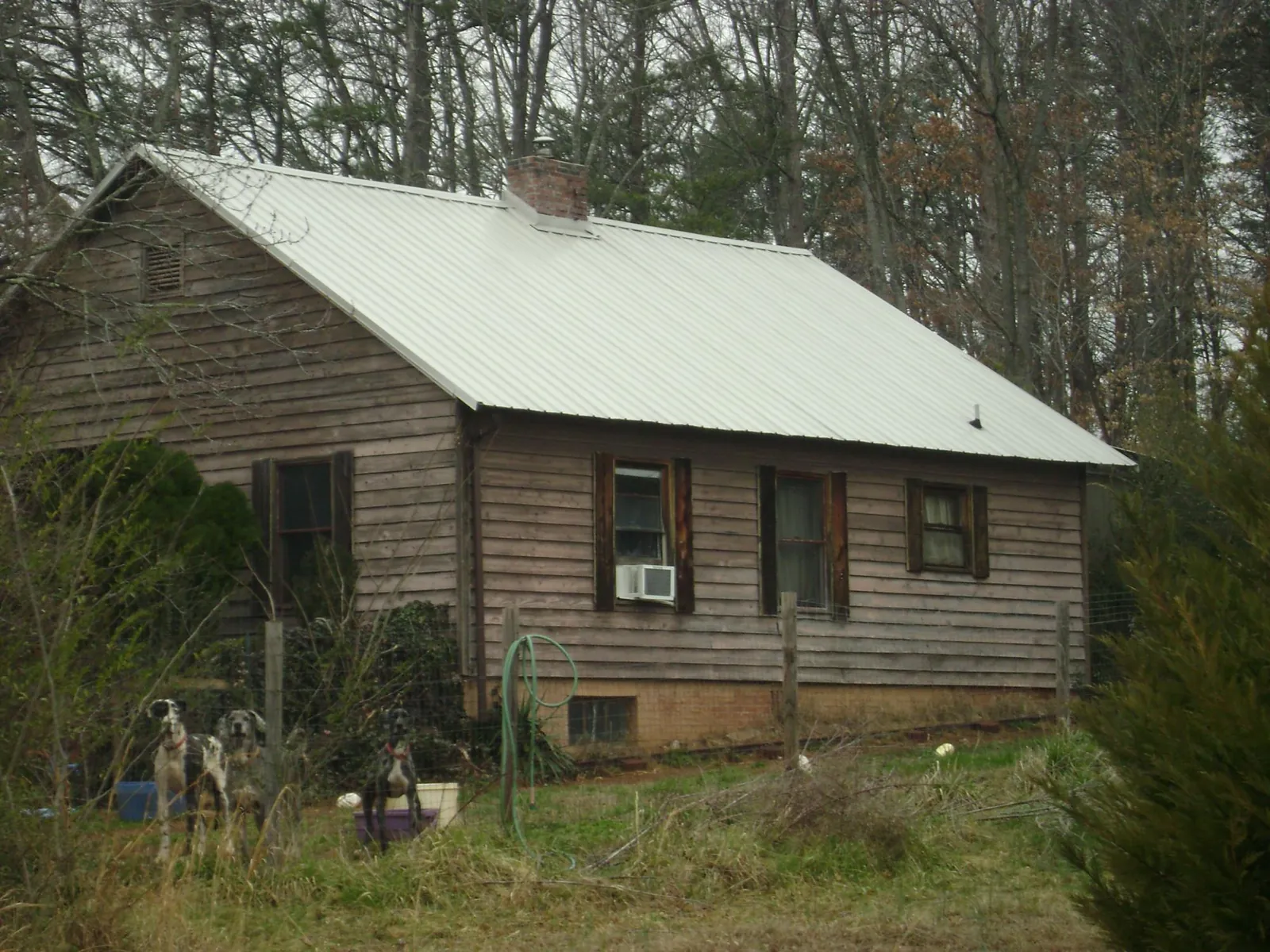 White metal roof on an old wood sided farmhouse, from a Metal Roof Installation job in Lookeba